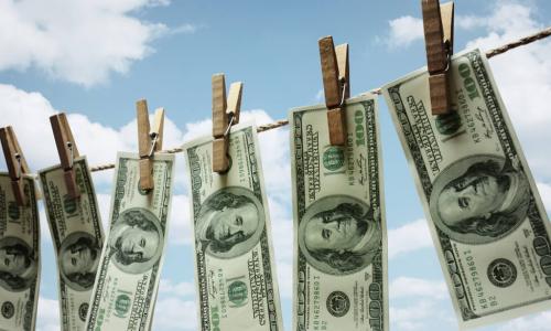 Dollar bills drying on a clothes line