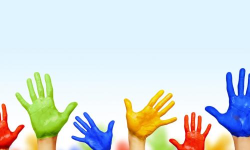 colorful painted hands raised to indicate consensus