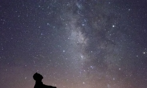 man looking at stars