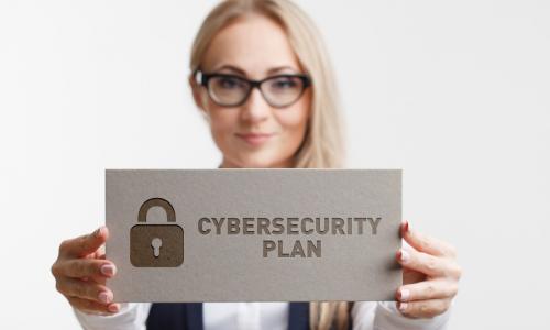 cybersecurity plan sign held by woman