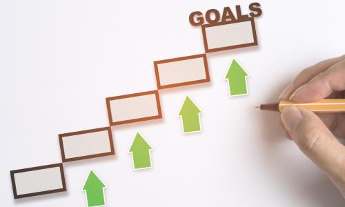 goals-check-boxes-green-arrows-hand-pencil