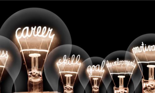 lightbulbs with glowing filaments in the shape of career and development related words