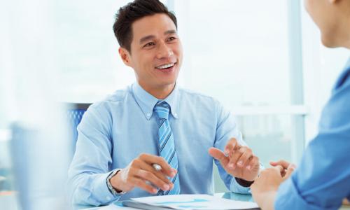 smiling engaged employee advises customer in office