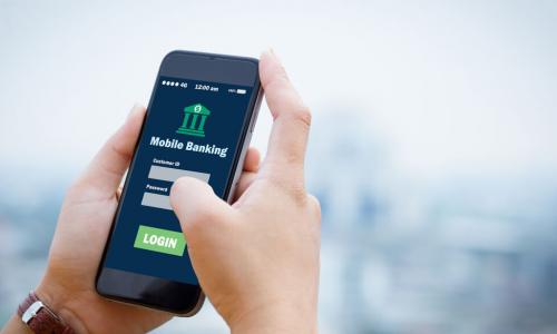 hands holding smartphone with mobile banking app login screen