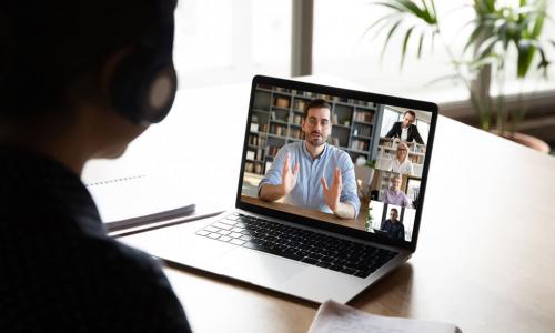 woman in virtual meeting with laptop