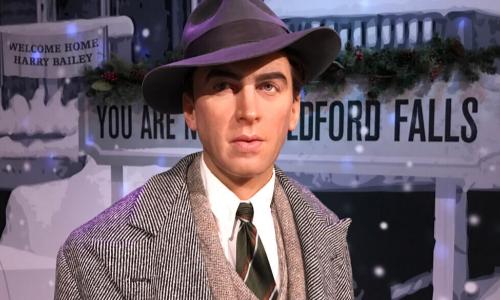 Jimmy Stewart figure in front of Bedford Falls sign from It’s a Wonderful Life
