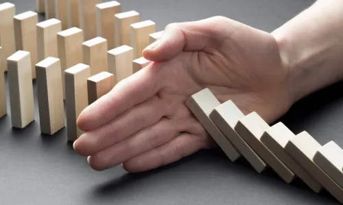 hand stopping falling blocks