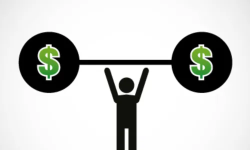 man holds dumbbell with dollar signs on balls