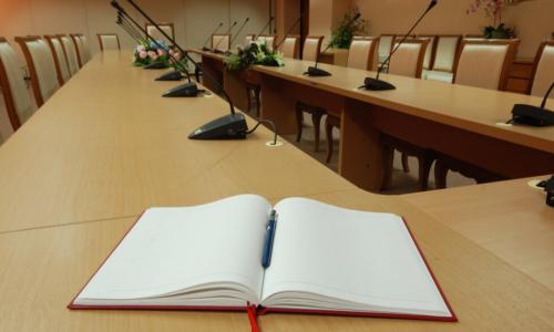 open notebook at a boardroom table