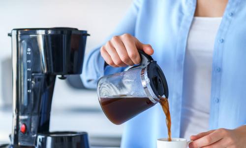 woman pouring morning coffee