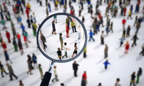 searching crowd of diverse people with magnifying glass for job candidate