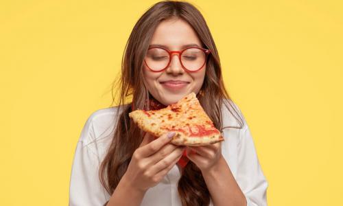 young person anticipates enjoying a slice of pizza