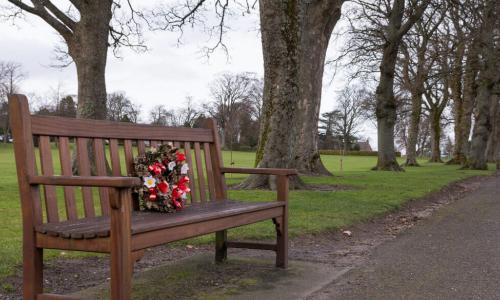 bench with a memorial wreath along pathway