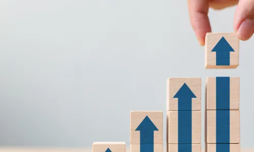 blue blocks that form arrows and a bar chart showing growth