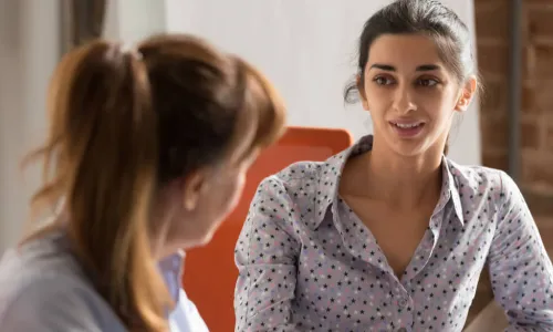 new young female manager coaching female employee