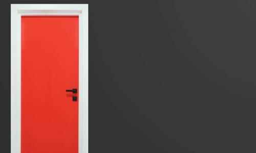Bright red door in a blank gray wall