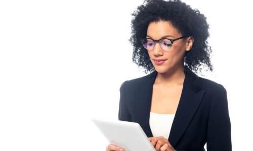 African-American businesswoman wearing glasses using a tablet