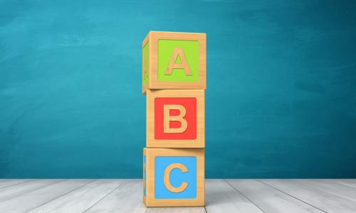 three toy blocks with the letters a, b and c