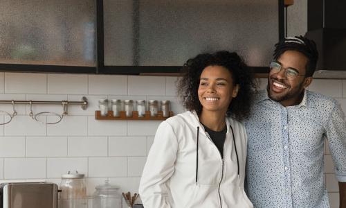 happy young Black couple in kitchen of new house