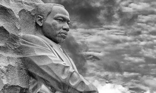 Martin Luther King Jr. memorial statue against cloudy sky