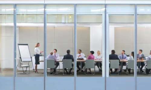 woman leading a board meeting wide view