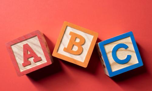 wooden alphabet blocks orange background