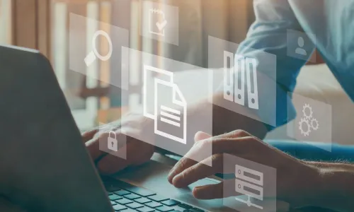 businessman with laptop and floating images