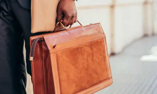 businessman walks with briefcase