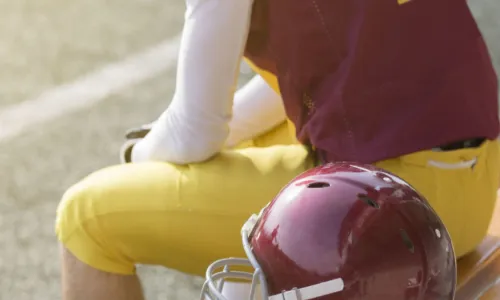 player with helmet on bench