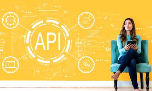 woman sitting in front of yellow background with API graphic