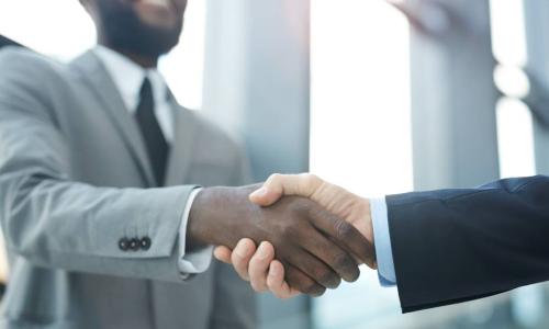 two businessmen shake hands