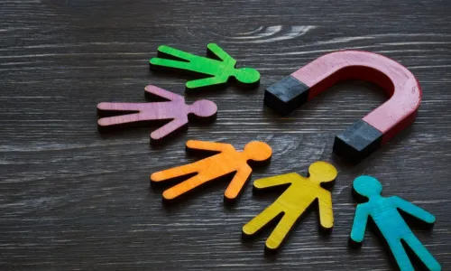 magnet attracting colorful cutouts of people