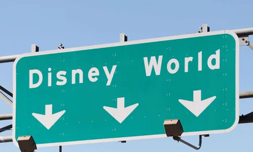 highway road sign pointing way to Disney world