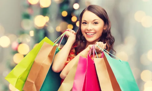 woman doing holiday shopping with colorful bags