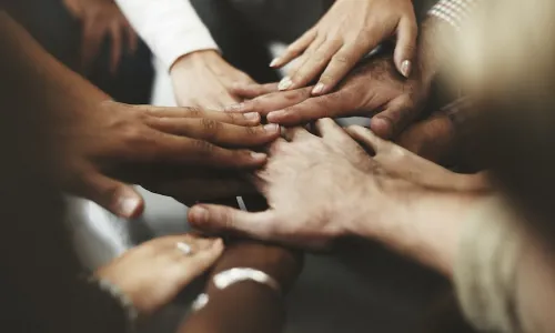 diverse hands together