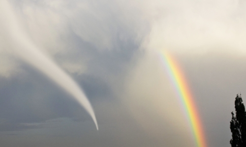 landscape with a tornado and rainbow