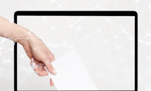 hand dropping ballot into digital computer screen to vote