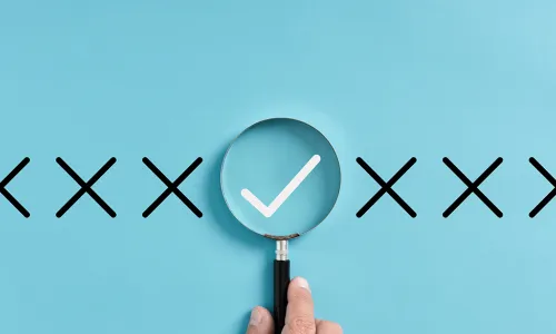 line of X's with a magnifying glass over the check mark