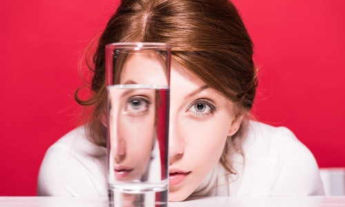 woman looking drinking glass