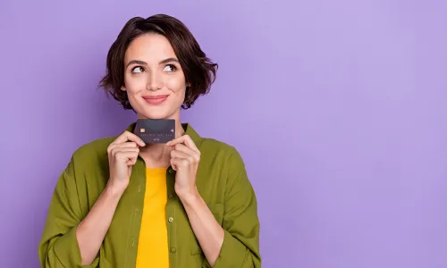 Woman smiling holding credit card