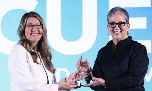 Julia receiving the award from Heather McKissick, CUES' CEO