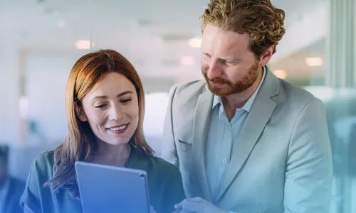 man and woman looking at a tablet