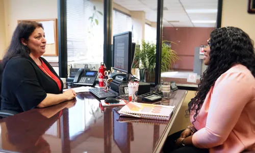 Erika Coleman meets with NOFFCU Financial Inclusion Manager Rachel Smith, CCUFC. The credit union’s personalized solutions helped Coleman take steps toward a solid financial future.