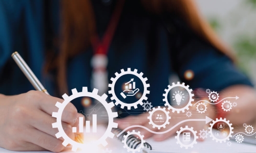 man writing in notebook with an overlay of gears with graphics inside of them