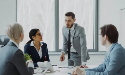 standing around table talking